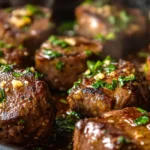 Juicy garlic steak bites in a cast-iron skillet with butter.