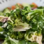 Delicious Chicken Salad Chick Broccoli Salad topped with cheese and bacon.