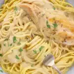 Slow Cooker Angel Chicken served over angel hair pasta with creamy sauce