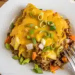 Delicious taco potato casserole with seasoned beef, creamy soup, and tender potatoes.