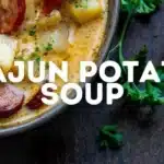Bowl of Cajun Potato Soup garnished with green onions and spices