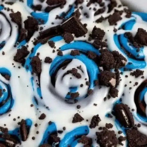 Delicious chocolate chip cinnamon rolls fresh out of the oven, drizzled with icing.