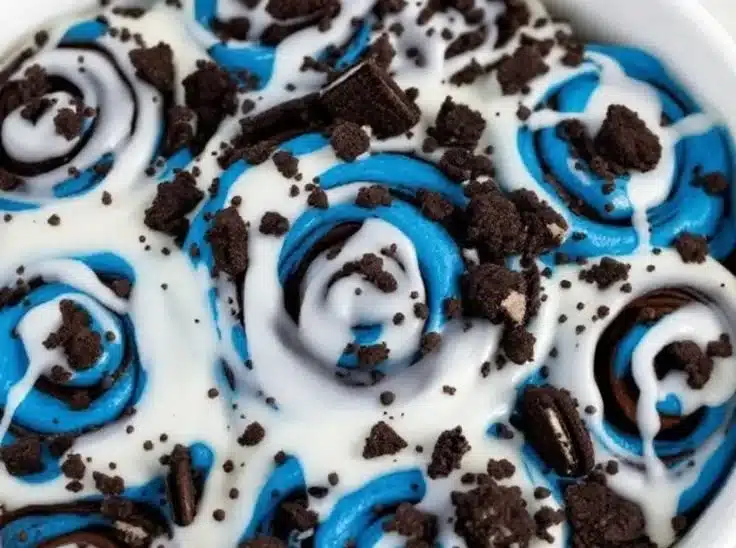 Delicious chocolate chip cinnamon rolls fresh out of the oven, drizzled with icing.