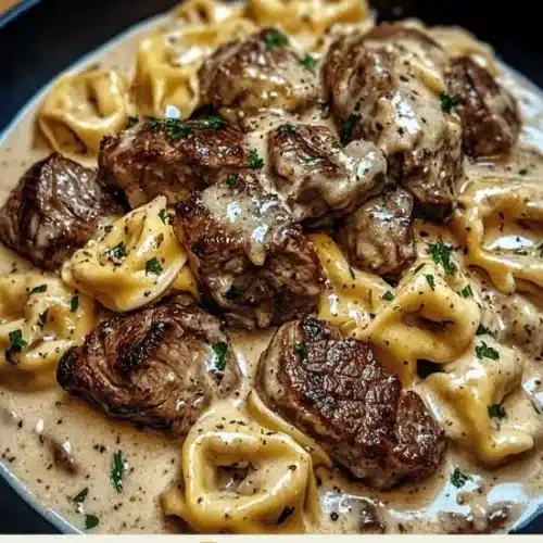 Cracked garlic steak tortellini in a creamy sauce with herbs and spices