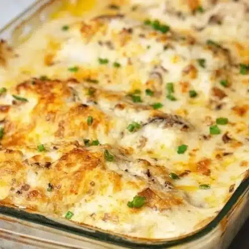 Delicious creamy baked chicken breasts served with herbs and vegetables.