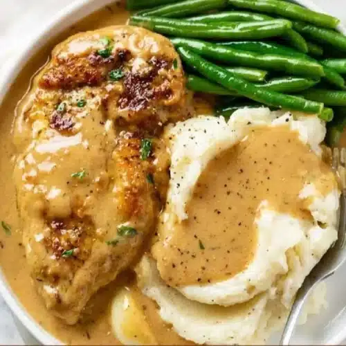 Plate of creamy garlic chicken with herbs and spices