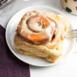 Freshly baked easy bread machine cinnamon rolls with icing on top.