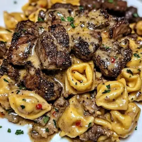One-pan cowboy butter tortellini with steak bites on a plate