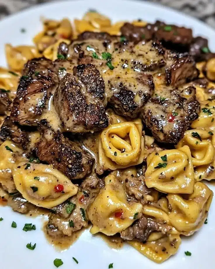 One-pan cowboy butter tortellini with steak bites on a plate