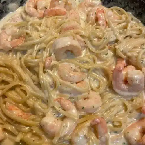 Delicious One Pan Shrimp Fettuccine Alfredo prepared and served in a skillet.
