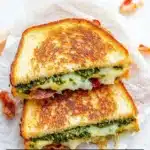 Pesto Grilled Cheese sandwich with melted cheese and basil pesto.