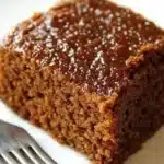 Quick and easy gingerbread cake fresh out of the oven topped with icing.