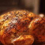 A beautifully roasted whole chicken served with herbs and vegetables
