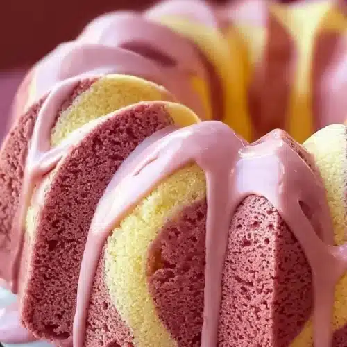 Slice of strawberry milkshake pound cake with strawberries and whipped cream