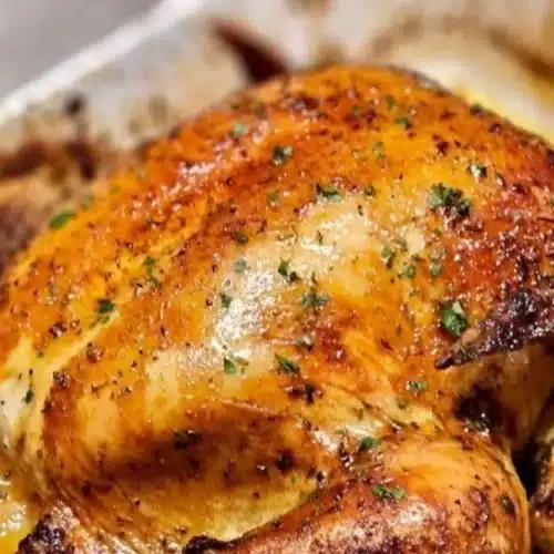 A beautifully roasted whole chicken served with herbs and vegetables