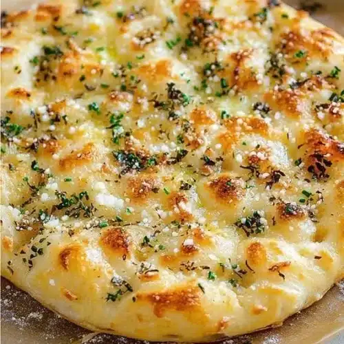 Garlic Parmesan Focaccia drizzled with spicy hot honey on a wooden board