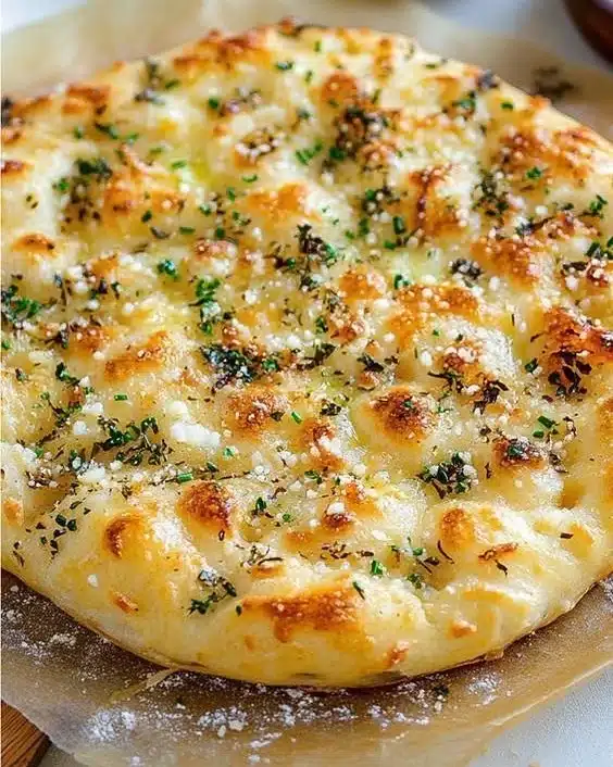 Garlic Parmesan Focaccia drizzled with spicy hot honey on a wooden board