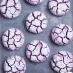 Freshly baked Purple Crinkle Cookies with a vibrant color and powdered sugar crust