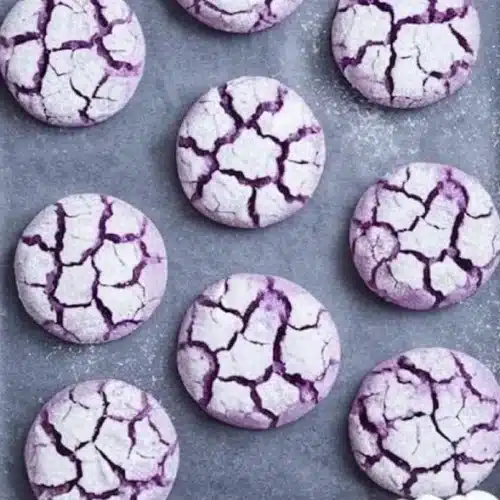 Freshly baked Purple Crinkle Cookies with a vibrant color and powdered sugar crust