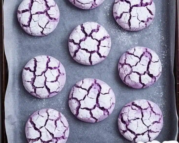 Freshly baked Purple Crinkle Cookies with a vibrant color and powdered sugar crust