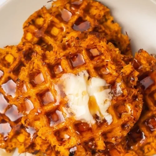 Delicious sweet potato waffles topped with syrup and fresh fruit