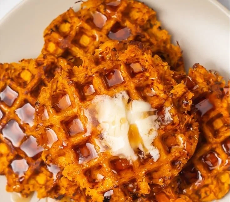 Delicious sweet potato waffles topped with syrup and fresh fruit