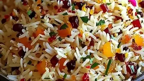 Bowl of Persian Jeweled Rice garnished with nuts and dried fruits