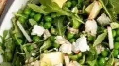 Fresh and vibrant pea salad with vegetables and dressing