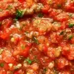 Freshly made homemade salsa in a bowl with chopped vegetables