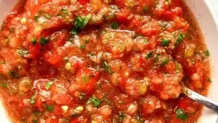 Freshly made homemade salsa in a bowl with chopped vegetables