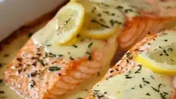 Baked salmon fillet with lemon butter cream sauce drizzled on top