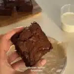 Delicious homemade brown butter brownies on a rustic wooden table.