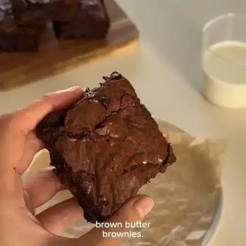 Delicious homemade brown butter brownies on a rustic wooden table.