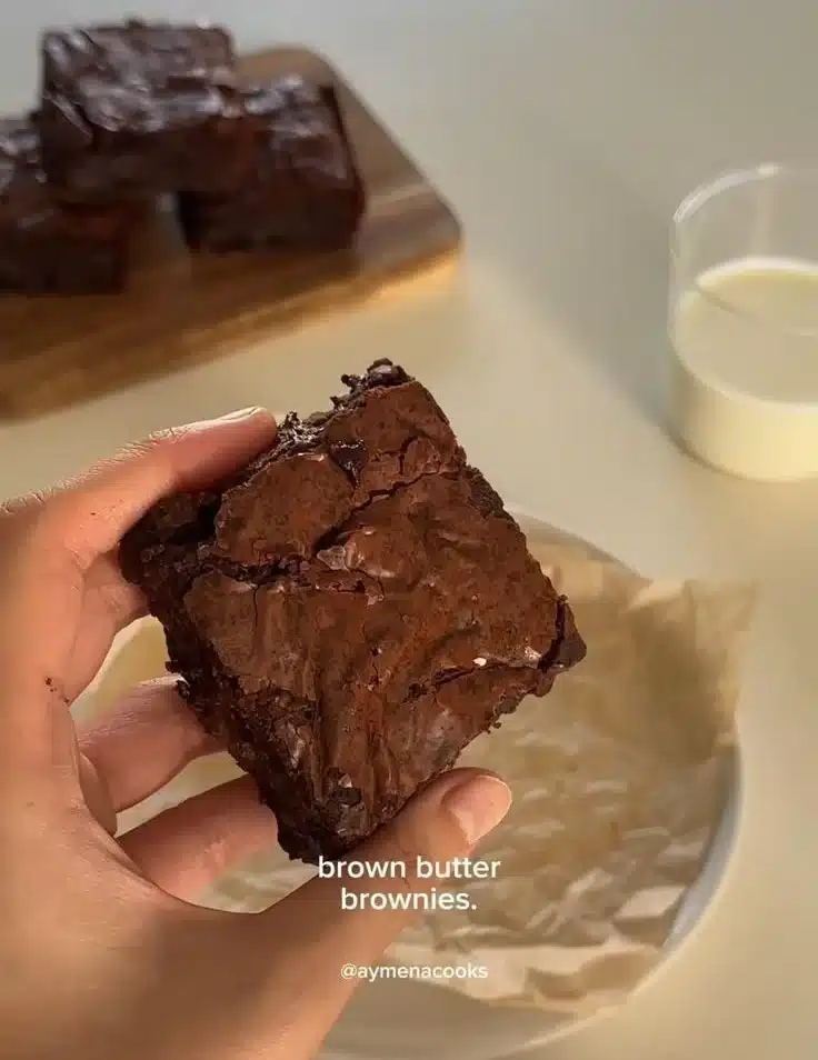 Delicious homemade brown butter brownies on a rustic wooden table.