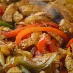 Plate of colorful chicken fajitas with peppers and onions