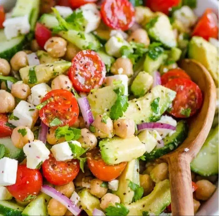 Colorful chickpea salad with fresh vegetables and dressing