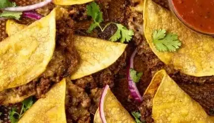 A delicious plate of crispy ground beef tacos topped with fresh ingredients