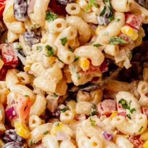 Bowl of vibrant Mexican macaroni salad with colorful veggies and seasoning