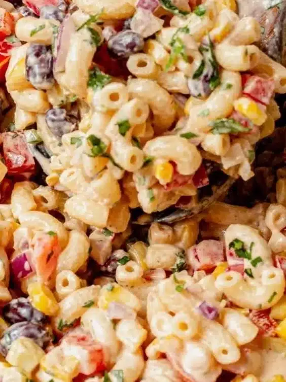Bowl of vibrant Mexican macaroni salad with colorful veggies and seasoning