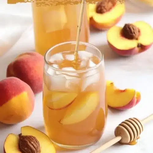 A refreshing glass of Southern Style Fresh Peach Sweet Tea with fresh peaches