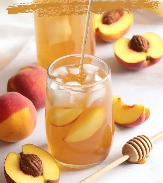 A refreshing glass of Southern Style Fresh Peach Sweet Tea with fresh peaches
